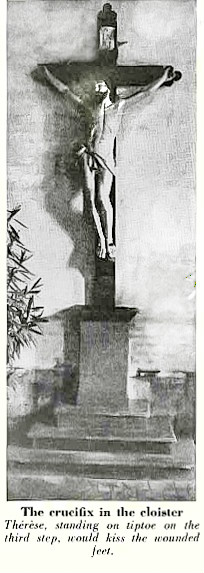 Black and white photo of big crucifix against cloister wall with three steps leading up to it