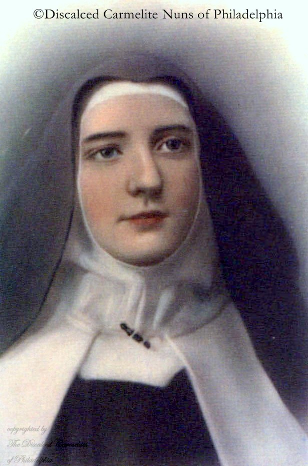 color portrait of Sister Stanislaus in black veil, brown Carmelite habit, and white cloak, head shot